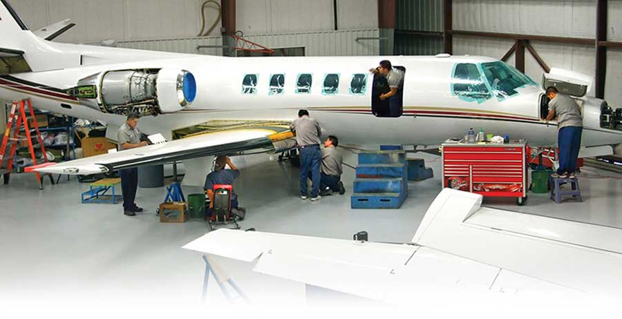 Crew working on Citation Jet engine